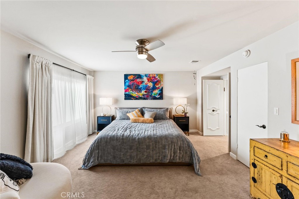 13243 Fiji Way, Unit K Marina del Rey, CA 90292 - Photo 26 of 39 a bedroom with a bed and a chandelier