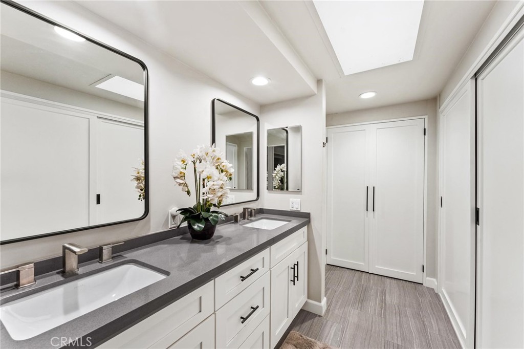 13243 Fiji Way, Unit K Marina del Rey, CA 90292 - Photo 29 of 39 a bathroom with double vanity sink a mirror and a shower