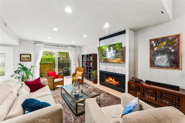 a living room with furniture fireplace and window