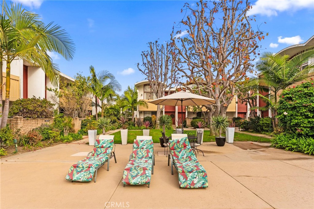 13243 Fiji Way, Unit K Marina del Rey, CA 90292 - Photo 36 of 39 a view of a patio with table and chairs under an umbrella