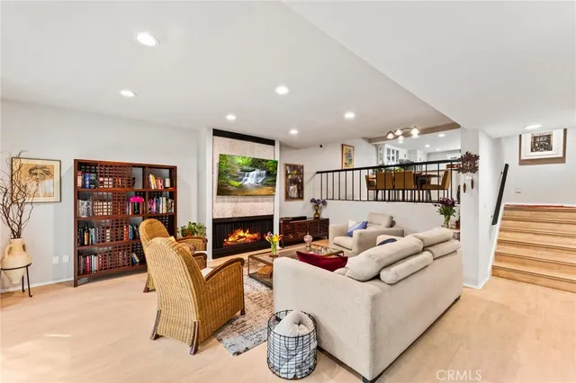 a living room with furniture fireplace and window