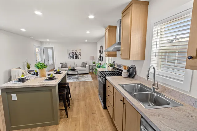 a kitchen with a sink stove top oven and cabinets