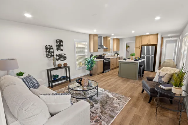 a living room with furniture rug and window