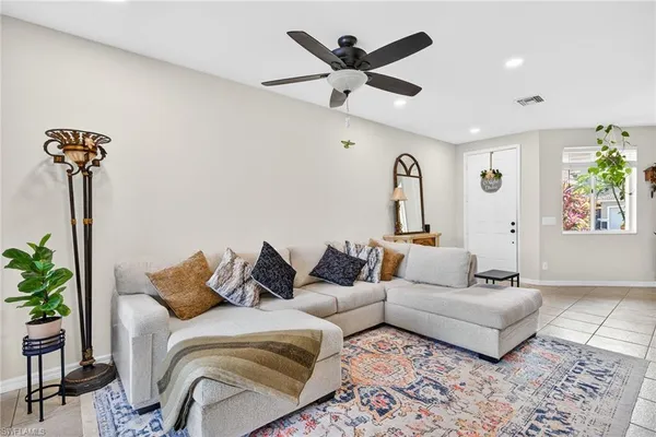 a living room with furniture and a potted plant