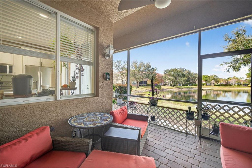 9530 Roundstone Circle Fort Myers, FL 33967 - Photo 23 of 35 a living room with furniture and a floor to ceiling window