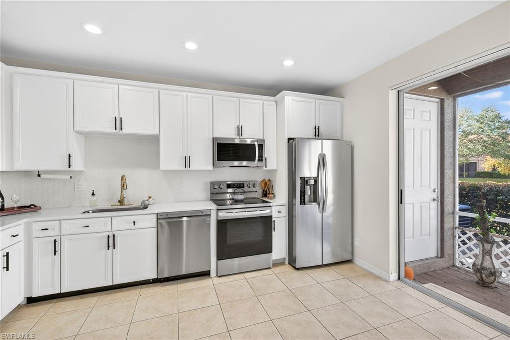 9530 Roundstone Circle Fort Myers, FL 33967 - Photo 8 of 35 a kitchen with stainless steel appliances granite countertop a refrigerator and a stove top oven