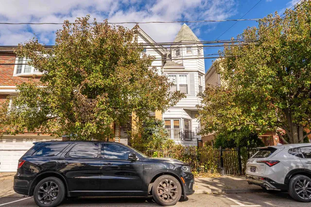 a front view of a house with parking space
