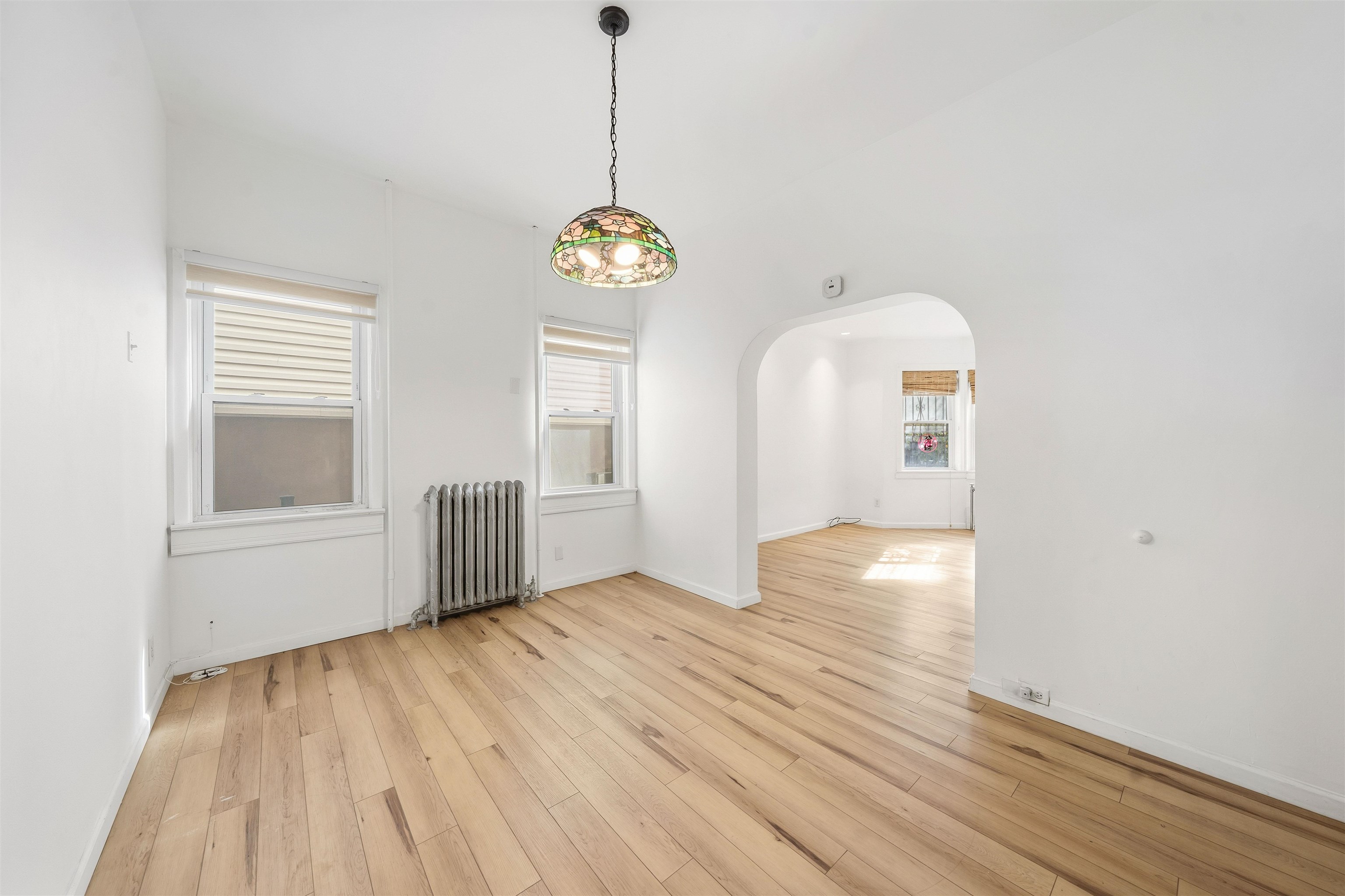 124 73rd Street, Unit 1 North Bergen, NJ 07047 - Photo 2 of 21 a view of empty room with wooden floor and window