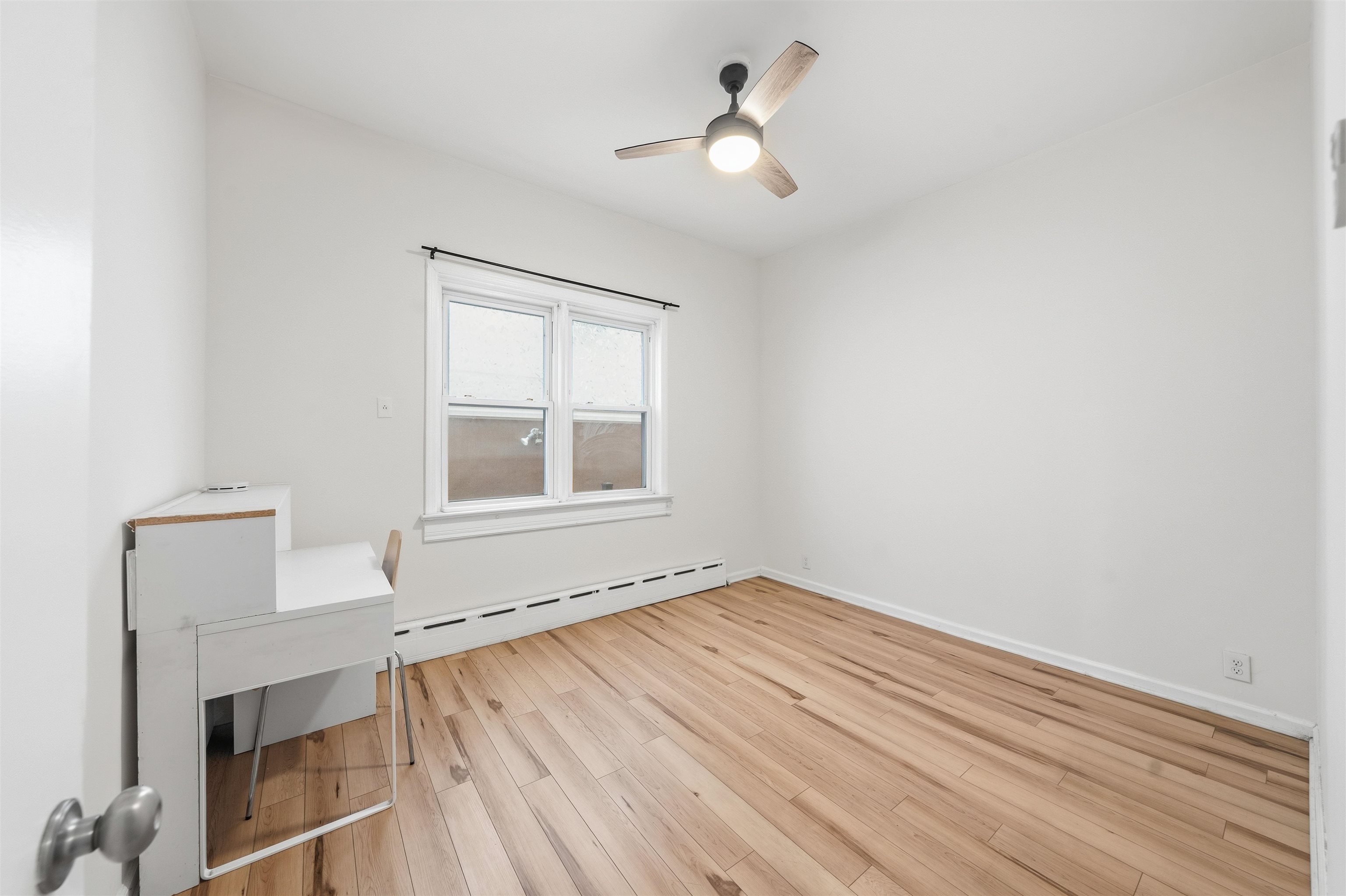 124 73rd Street, Unit 1 North Bergen, NJ 07047 - Photo 7 of 21 a view of empty room with wooden floor and fan