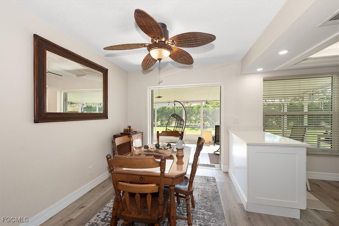 2124 Northeast 3rd Terrace Cape Coral, FL 33909 - Photo 11 of 32 a dining room with furniture a chandelier and a large window
