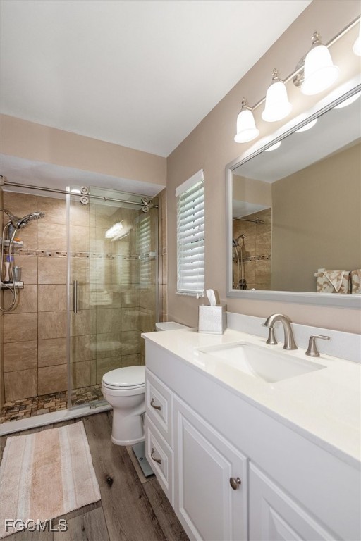 2124 Northeast 3rd Terrace Cape Coral, FL 33909 - Photo 19 of 32 a bathroom with a double vanity sink toilet and shower
