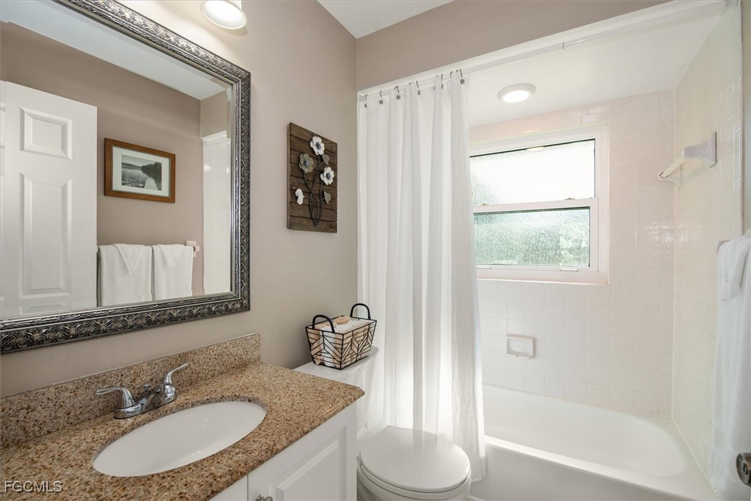 2124 Northeast 3rd Terrace Cape Coral, FL 33909 - Photo 22 of 32 a bathroom with a granite countertop sink toilet and shower