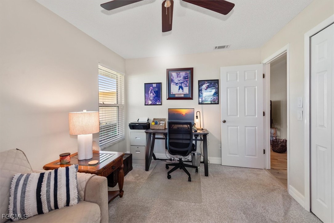 2124 Northeast 3rd Terrace Cape Coral, FL 33909 - Photo 25 of 32 a work room with furniture and a lamp