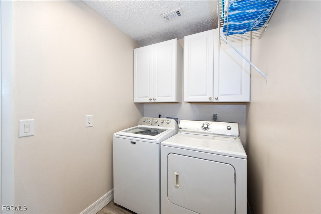 2124 Northeast 3rd Terrace Cape Coral, FL 33909 - Photo 26 of 32 a utility room with dryer and washer