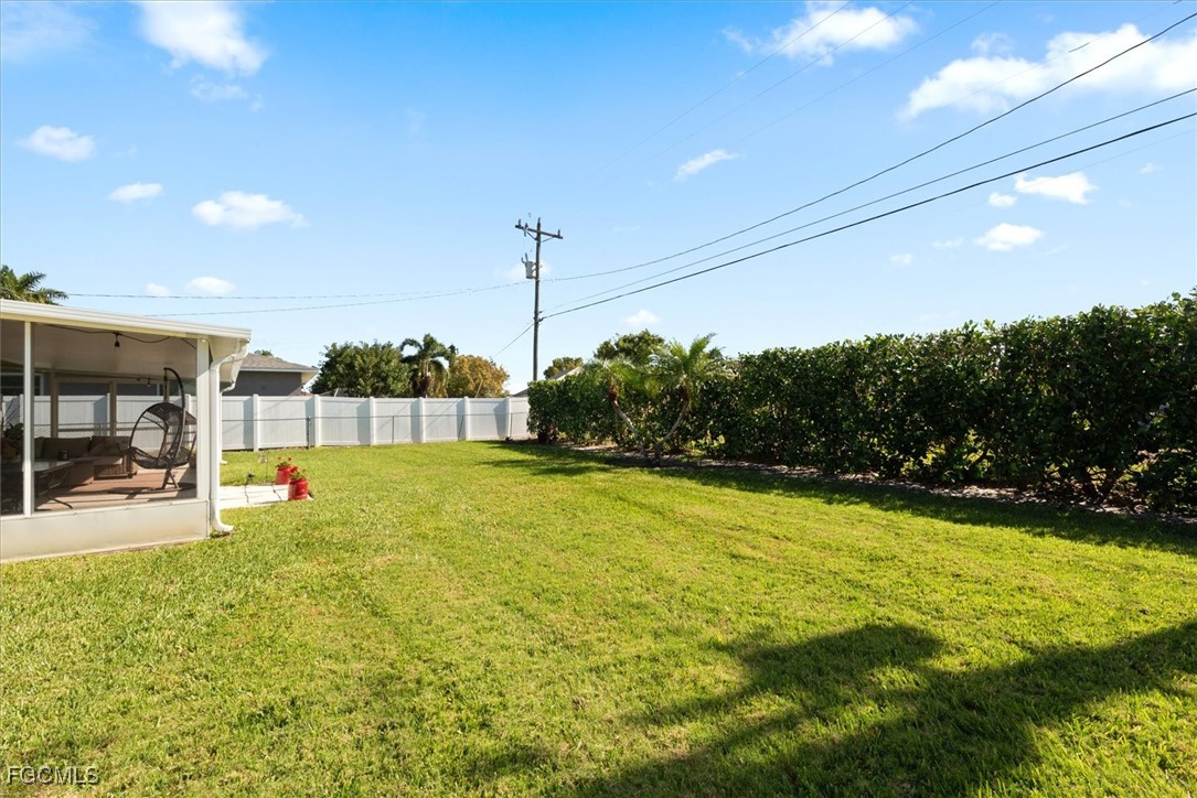 2124 Northeast 3rd Terrace Cape Coral, FL 33909 - Photo 29 of 32 a view of a swimming pool with an outdoor seating and a yard
