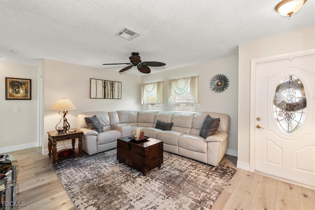 2124 Northeast 3rd Terrace Cape Coral, FL 33909 - Photo 6 of 32 a living room with furniture and a window
