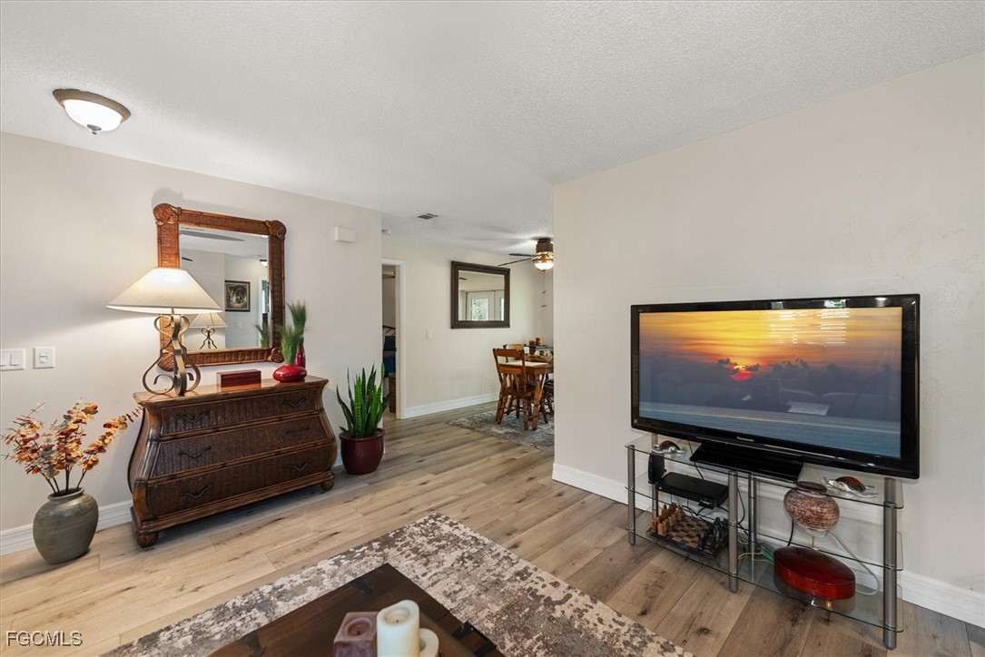 2124 Northeast 3rd Terrace Cape Coral, FL 33909 - Photo 7 of 32 a living room with furniture and a flat screen tv