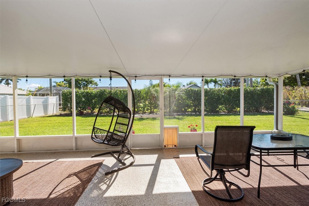 2124 Northeast 3rd Terrace Cape Coral, FL 33909 - Photo 9 of 32 a view of a swimming pool with a table and chairs in the patio