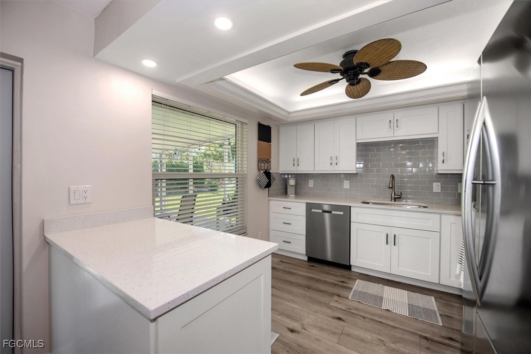 2124 Northeast 3rd Terrace Cape Coral, FL 33909 - Photo 10 of 32 a kitchen with stainless steel appliances a stove a sink and a refrigerator