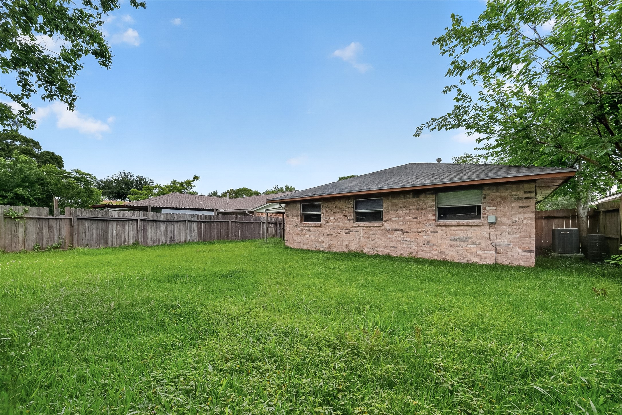 4826 Redfish Reef Drive Bacliff, TX 77518 - Photo 25 of 25 a backyard of a house with lots of green space