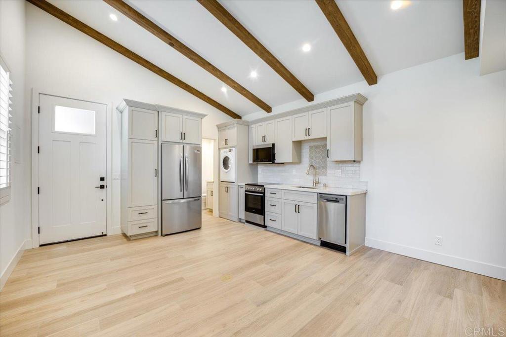 a kitchen with stainless steel appliances a refrigerator sink and cabinets