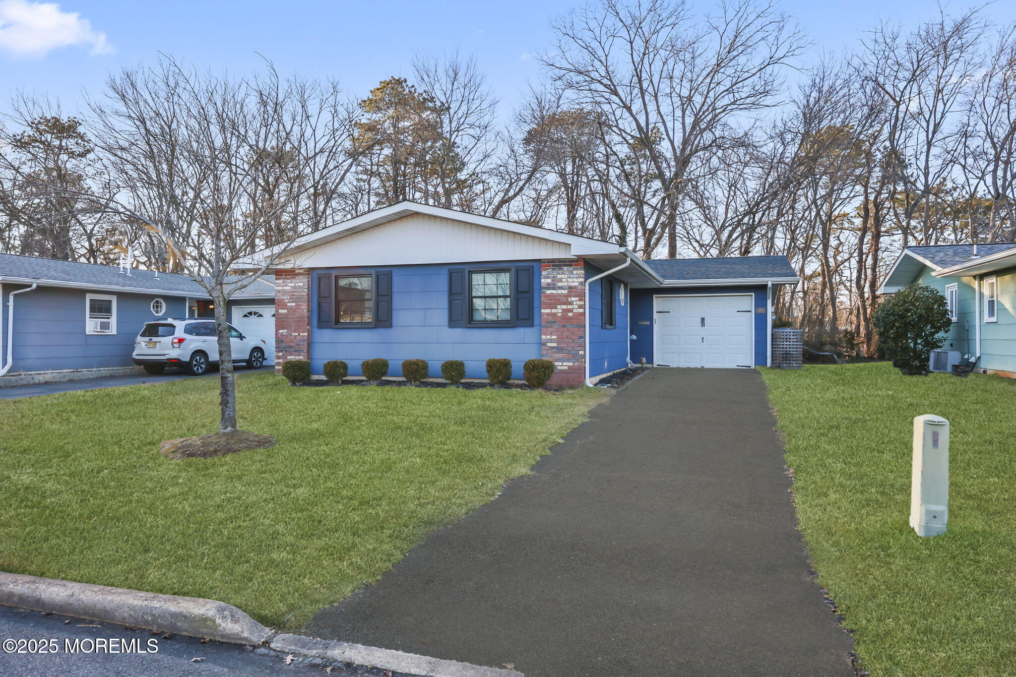 49 Markham Road Brick, NJ 08724 - Photo 2 of 21 a front view of a house with a yard and trees
