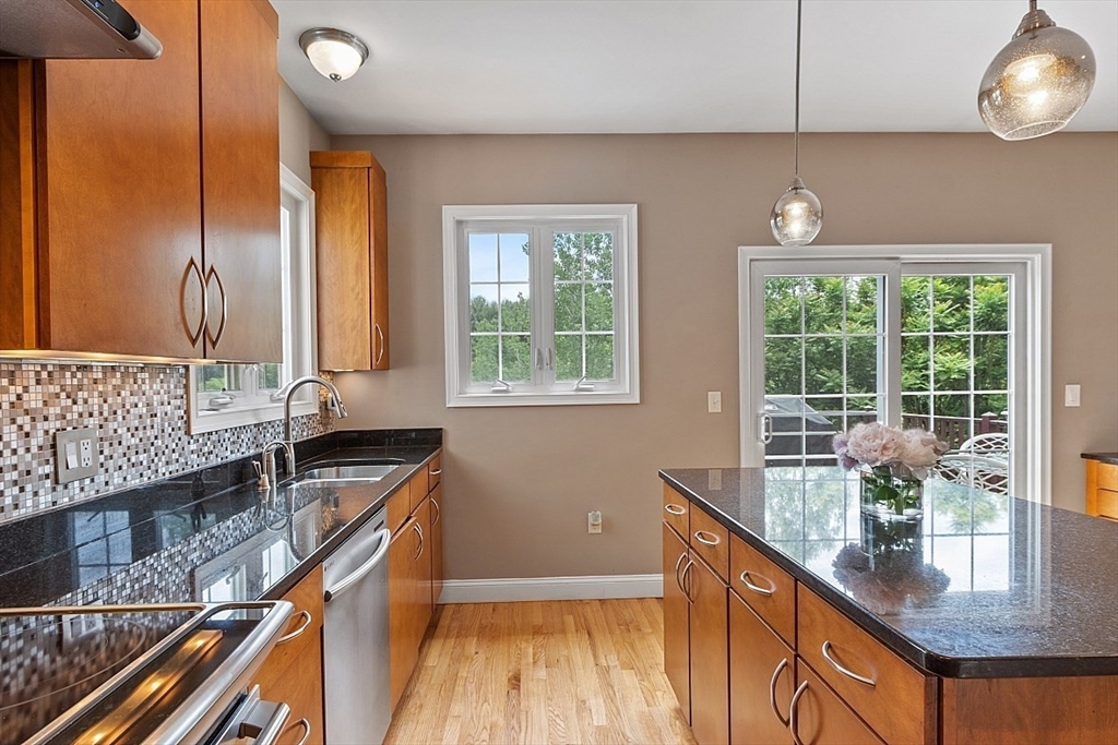 204 Littleton County Road Harvard, MA 01451 - Photo 11 of 42 a kitchen with stainless steel appliances granite countertop a sink a stove and a wooden floors