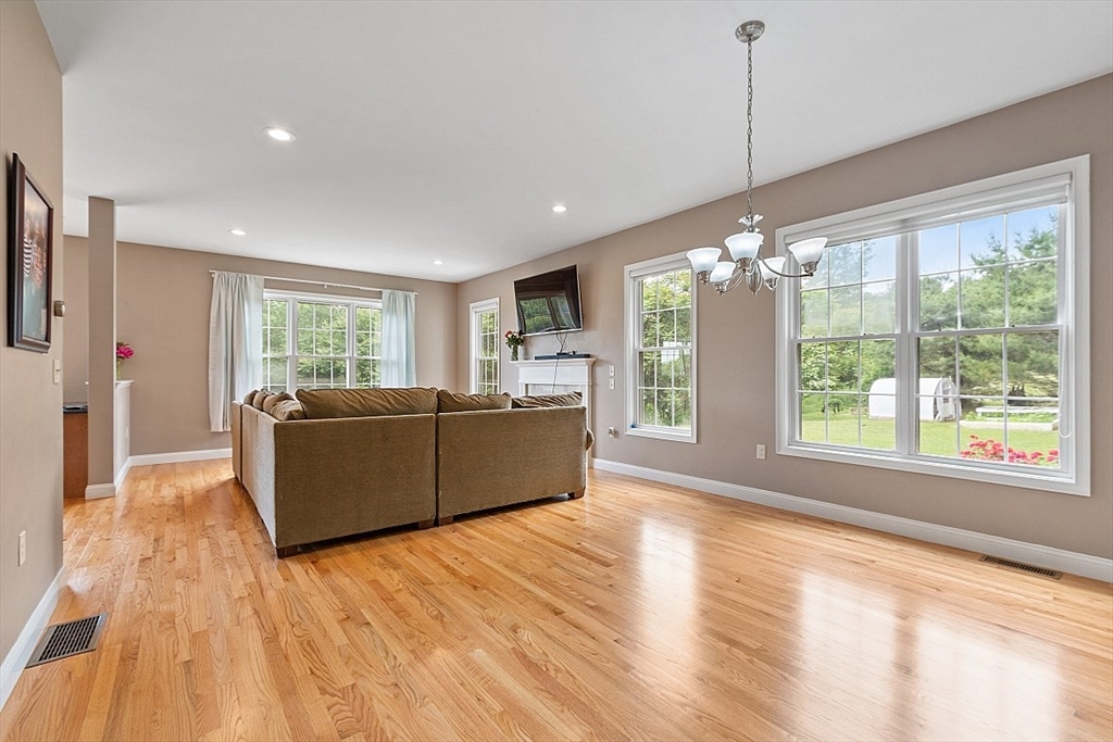 204 Littleton County Road Harvard, MA 01451 - Photo 13 of 42 a living room with furniture and a chandelier