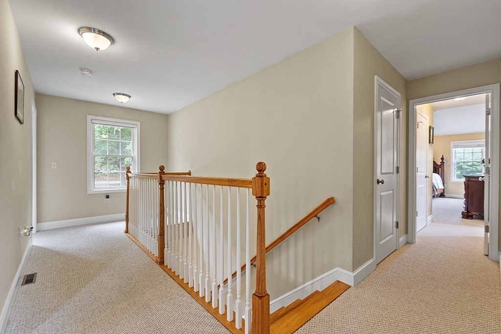 204 Littleton County Road Harvard, MA 01451 - Photo 18 of 42 a view of a hallway with a large window and stairs