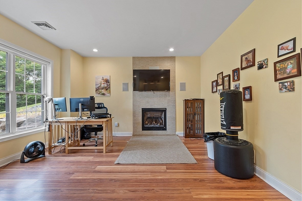 204 Littleton County Road Harvard, MA 01451 - Photo 30 of 42 a living room with furniture and a fireplace