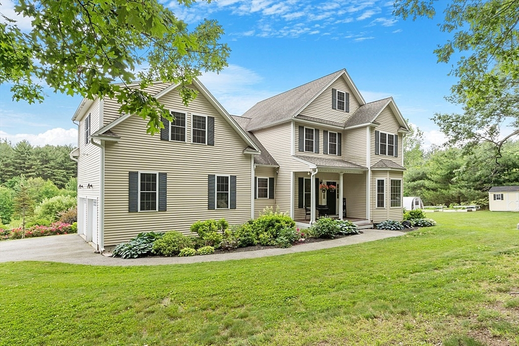 204 Littleton County Road Harvard, MA 01451 - Photo 3 of 42 a front view of a house with garden