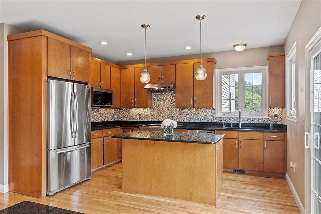 204 Littleton County Road Harvard, MA 01451 - Photo 8 of 42 a kitchen with stainless steel appliances granite countertop a sink a refrigerator and cabinets