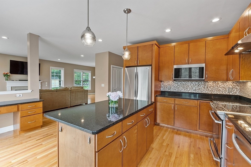 204 Littleton County Road Harvard, MA 01451 - Photo 10 of 42 a kitchen with stainless steel appliances granite countertop a sink a stove and a refrigerator