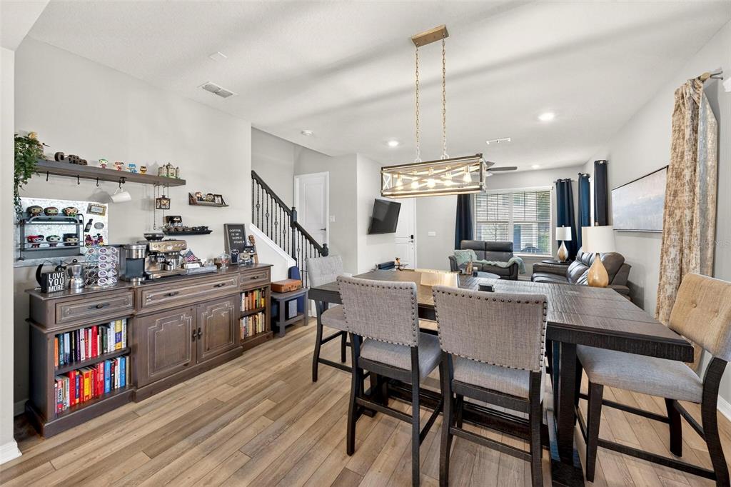 2100 Gopher Tortoise Terrace Oakland, FL 34787 - Photo 12 of 58 a kitchen with kitchen island a dining table chairs stainless steel appliances and cabinets