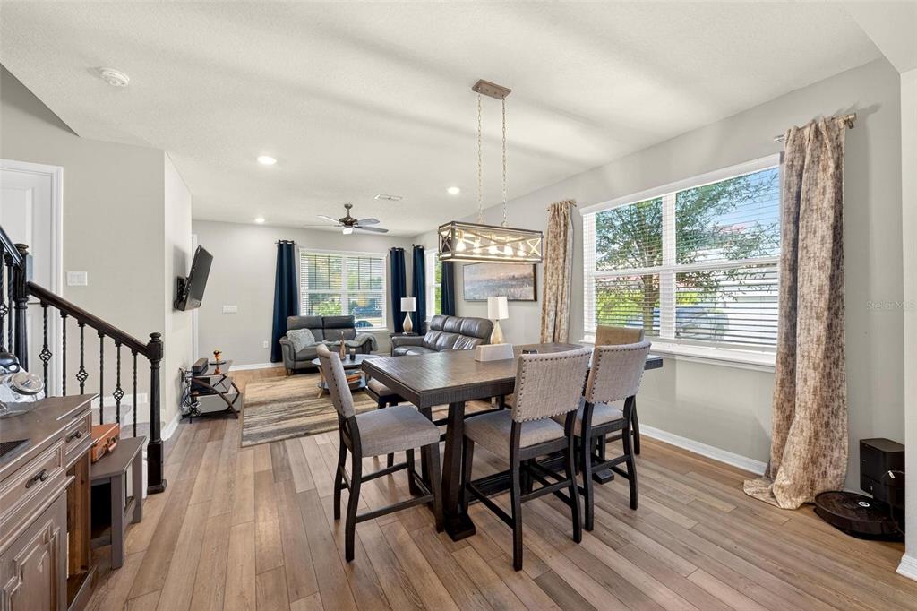 2100 Gopher Tortoise Terrace Oakland, FL 34787 - Photo 13 of 58 a view of a dining room with furniture window and wooden floor