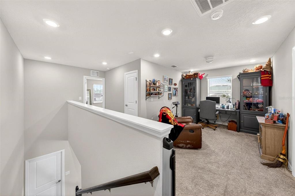 2100 Gopher Tortoise Terrace Oakland, FL 34787 - Photo 25 of 58 a living room with furniture and a flat screen tv