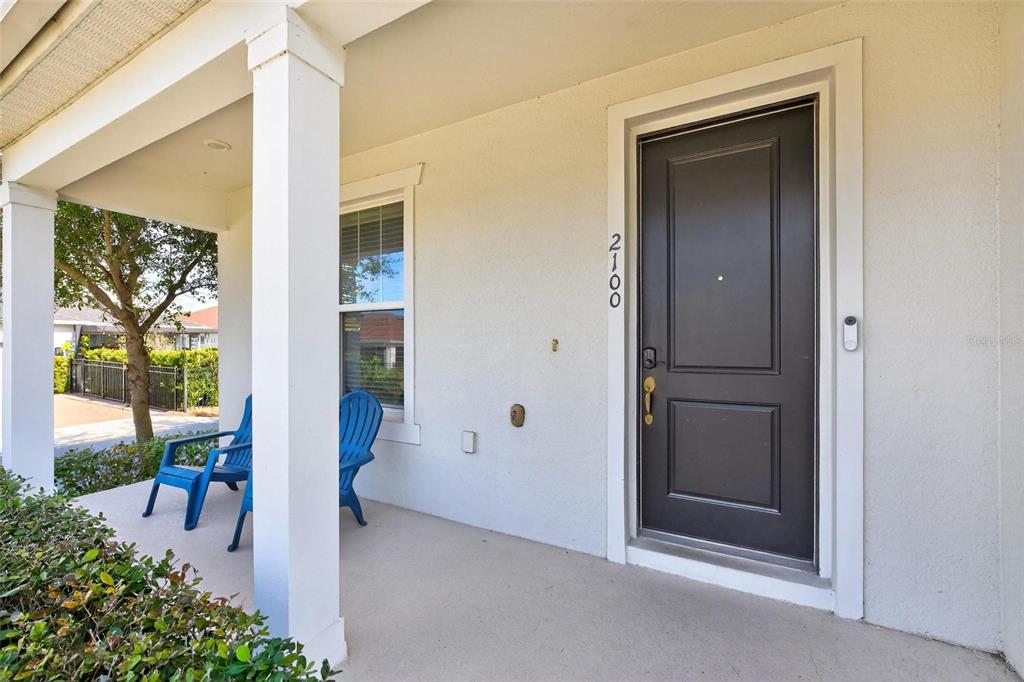 2100 Gopher Tortoise Terrace Oakland, FL 34787 - Photo 3 of 58 a view of a porch with a table and chairs and potted plants