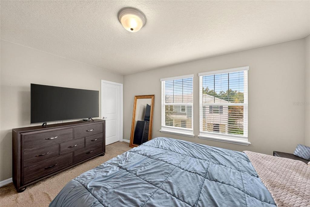 2100 Gopher Tortoise Terrace Oakland, FL 34787 - Photo 33 of 58 a bedroom with a bed and a flat screen television