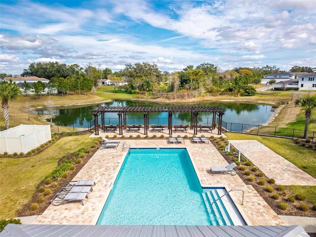 2100 Gopher Tortoise Terrace Oakland, FL 34787 - Photo 53 of 58 a view of swimming pool with outdoor seating and a lake view