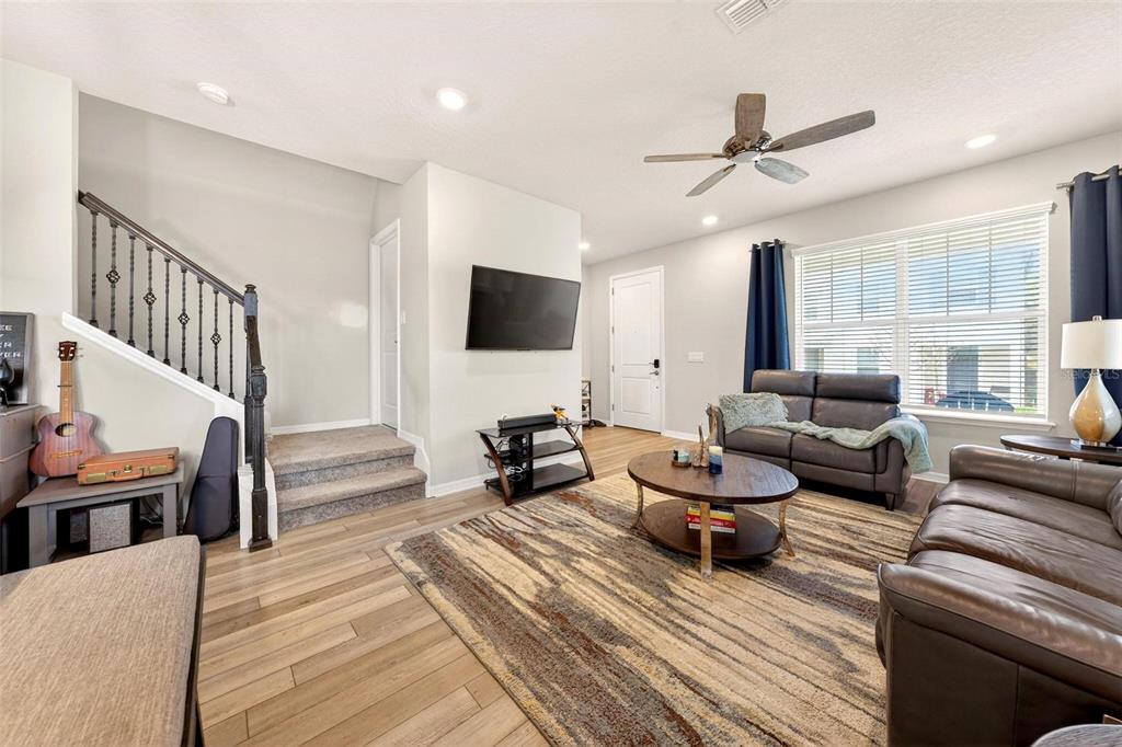2100 Gopher Tortoise Terrace Oakland, FL 34787 - Photo 6 of 58 a living room with furniture and a flat screen tv