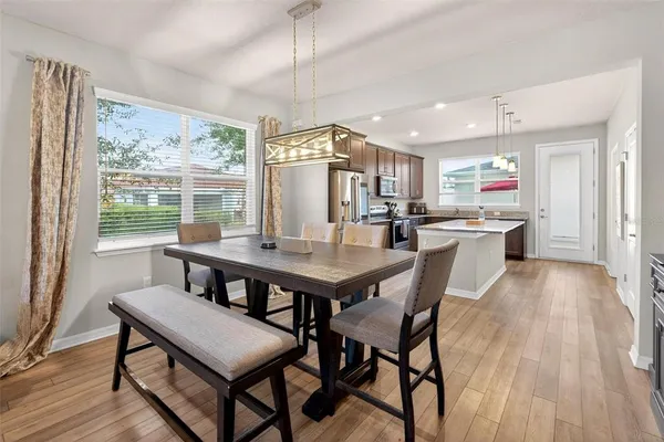 a view of a dining room with furniture window and wooden floor