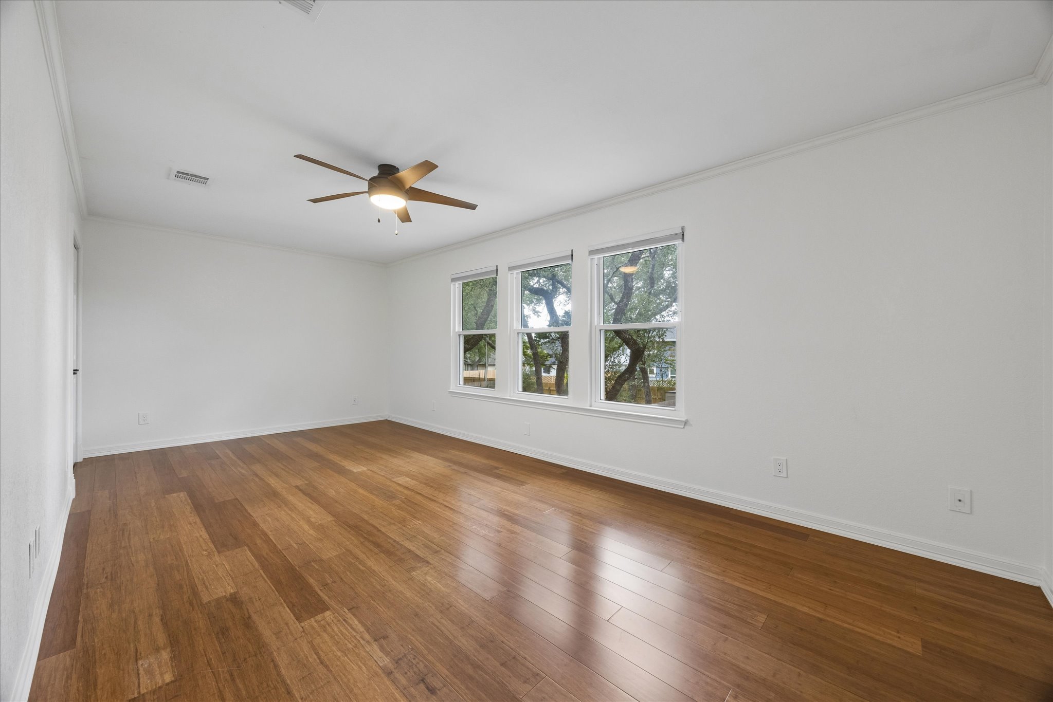 1306 Shady Grove Path Cedar Park, TX 78613 - Photo 25 of 40 a view of an empty room with wooden floor and a window