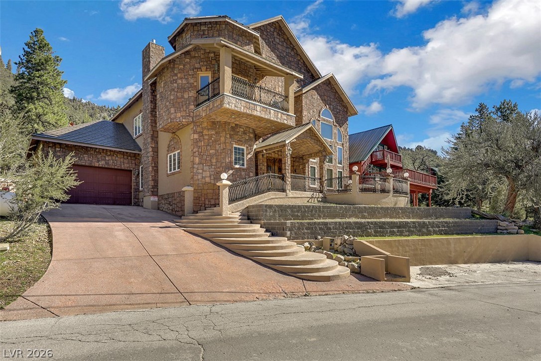 264 Crestview Drive Mount Charleston, NV 89124 - Photo 1 of 78 This majestic stone exterior home features a grand driveway and elegant architectural details.