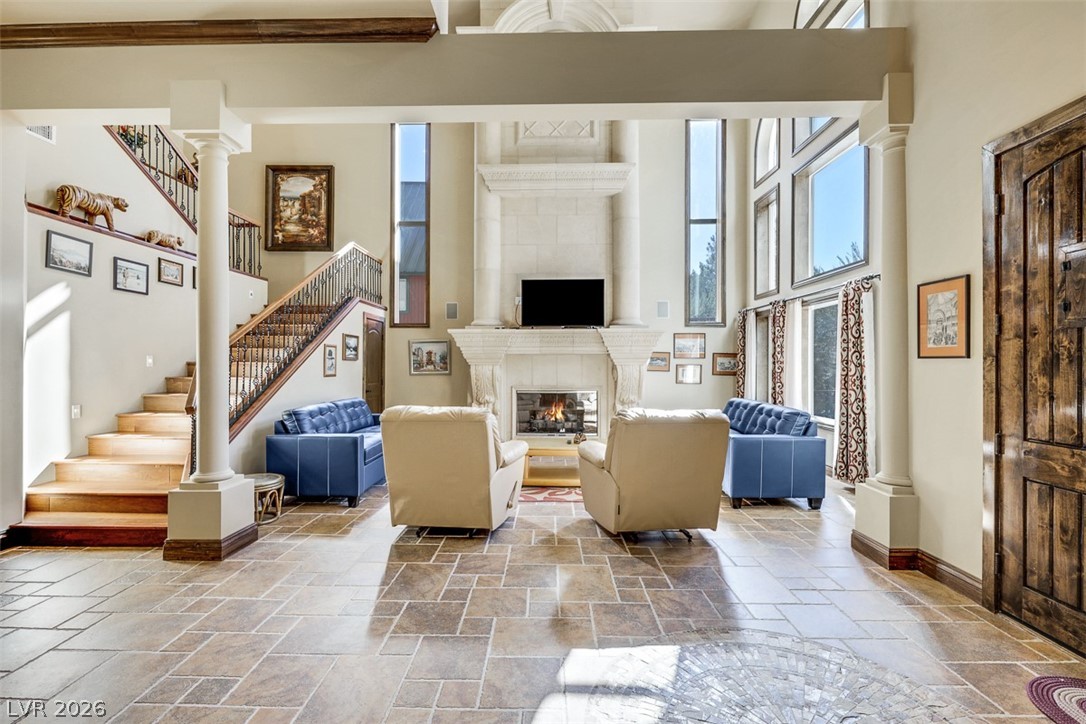 264 Crestview Drive Mount Charleston, NV 89124 - Photo 14 of 78 This grand room features a majestic fireplace, high ceilings, and an elegant staircase.