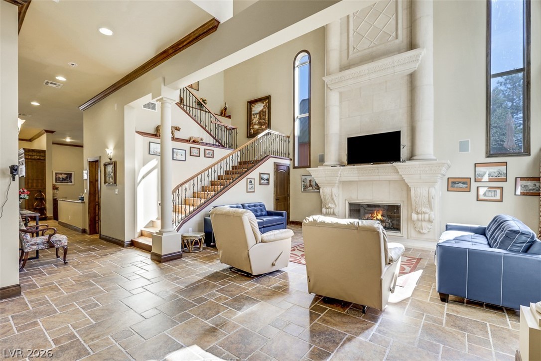 264 Crestview Drive Mount Charleston, NV 89124 - Photo 15 of 78 Grand living area with high ceilings, an elegant fireplace, and a sweeping staircase.