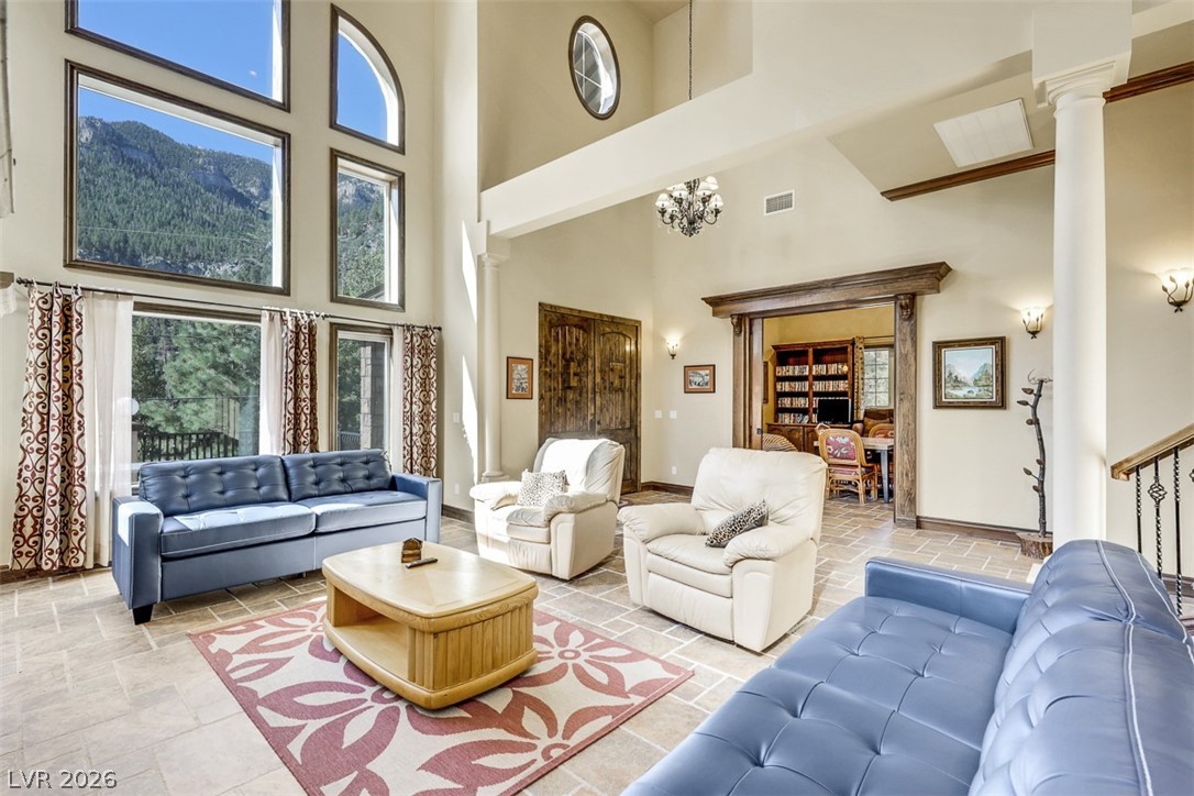 264 Crestview Drive Mount Charleston, NV 89124 - Photo 17 of 78 This living area features a dramatic two-story ceiling, offering panoramic views of the mountains.