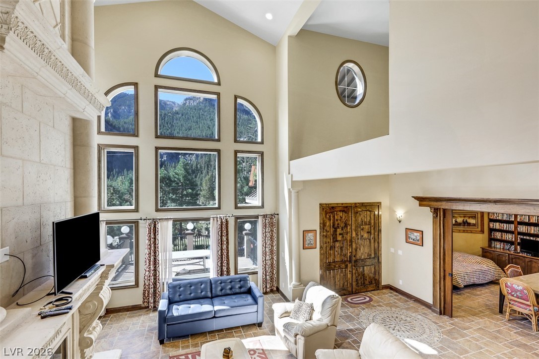 264 Crestview Drive Mount Charleston, NV 89124 - Photo 19 of 78 This grand living room features high ceilings and panoramic views of the surrounding mountains.