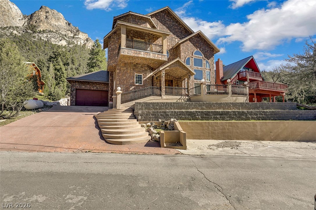 264 Crestview Drive Mount Charleston, NV 89124 - Photo 2 of 78 This majestic mountain retreat features a stone facade and spacious balconies, set against a stunning natural backdrop.