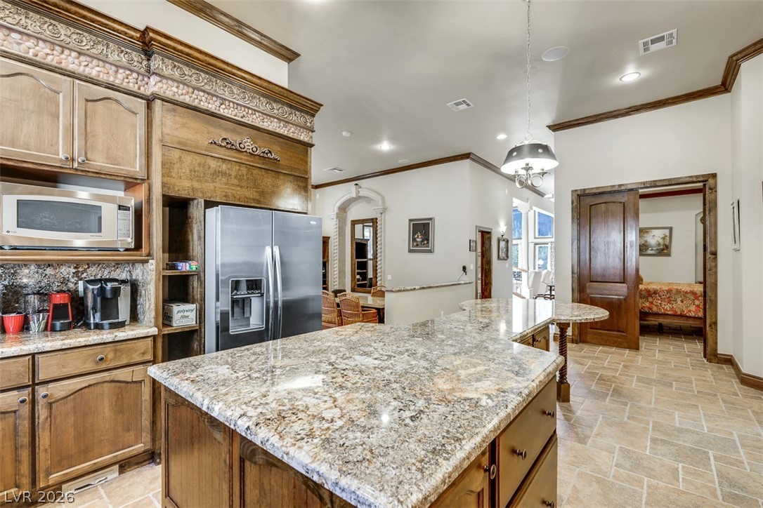 264 Crestview Drive Mount Charleston, NV 89124 - Photo 28 of 78 This kitchen features rich wooden cabinetry and stone tile flooring, offering both elegance and durability.