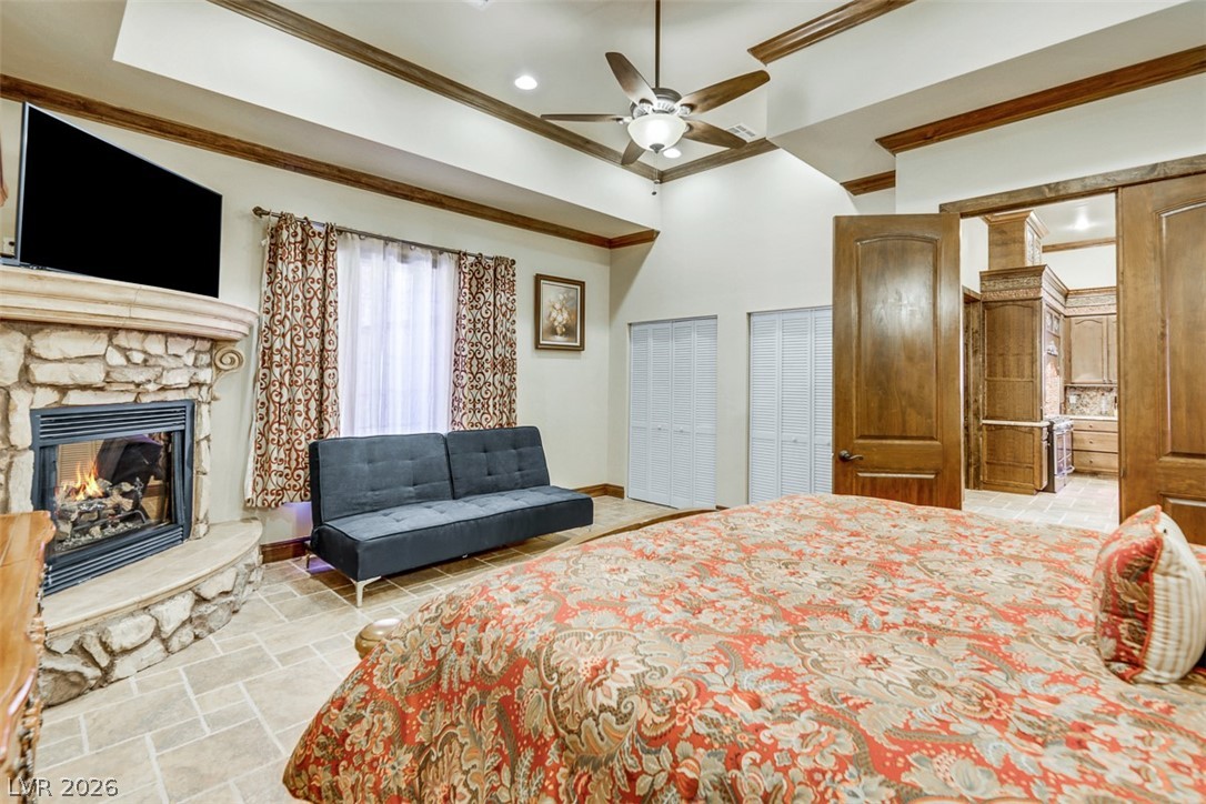264 Crestview Drive Mount Charleston, NV 89124 - Photo 39 of 78 This spacious bedroom features a cozy fireplace, tiled flooring, and elegant ceiling details for ultimate comfort.